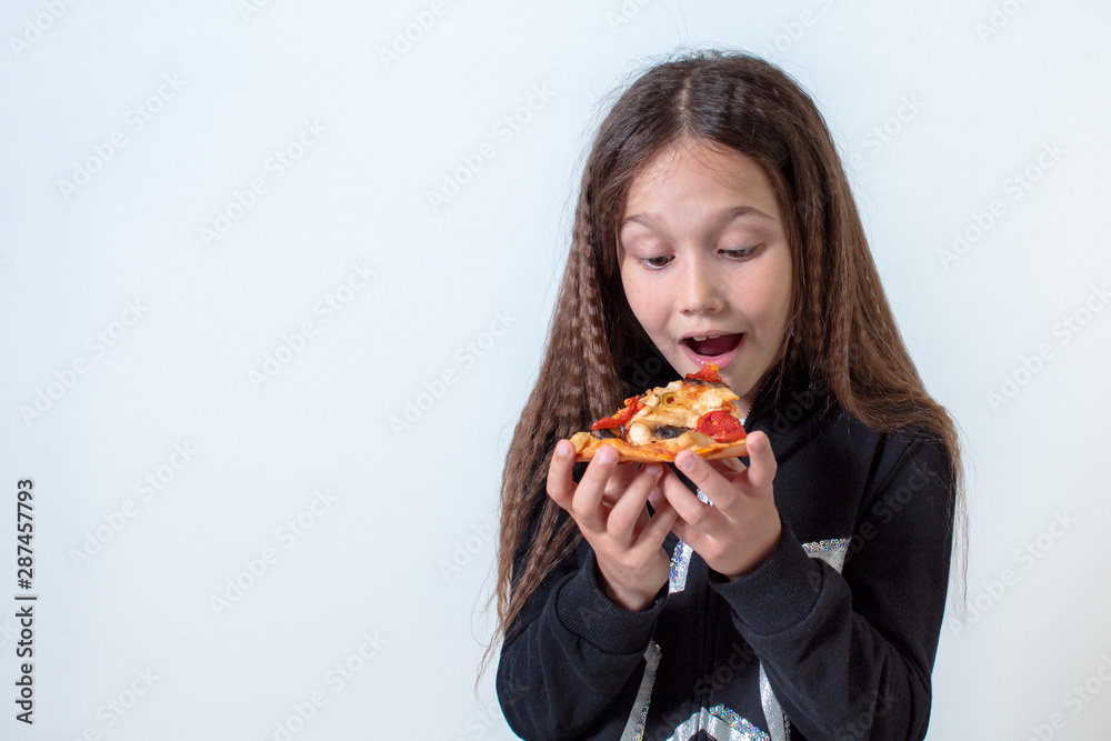 Little girl eating pizza. Baby puts pizza in her mouth Little girl eating pizza. Baby puts pizza in her mouth