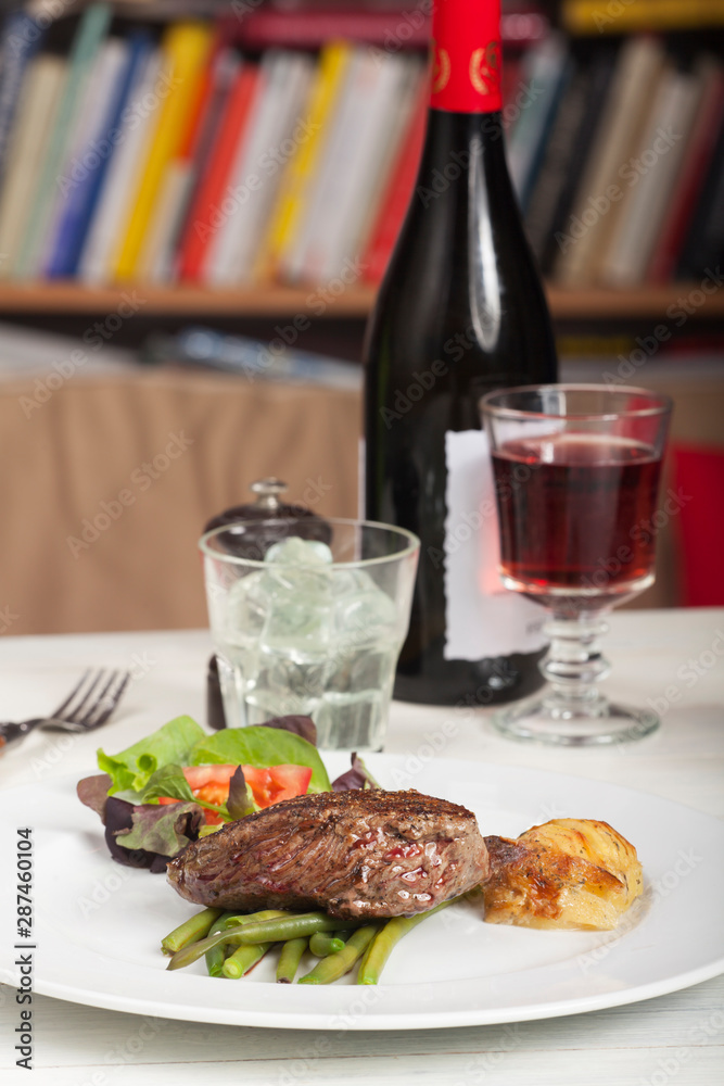 slices of a steak on wood with rosemary slices of a steak on wood with rosemary