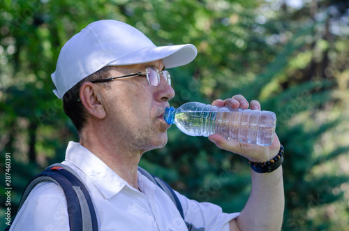 The 50s age man is drinking water