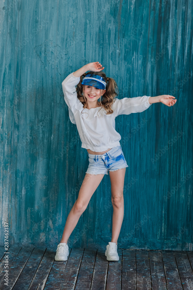 Laughing beautiful teen girl in sports wear dance and swing by her hands Laughing beautiful teen girl in sports wear dance and swing by her hands