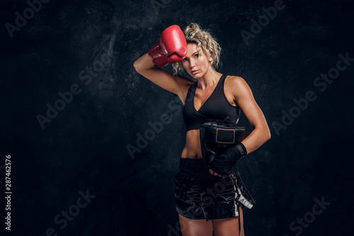 Attractive blond woman feels tired after long hard boxing match. © Fxquadro