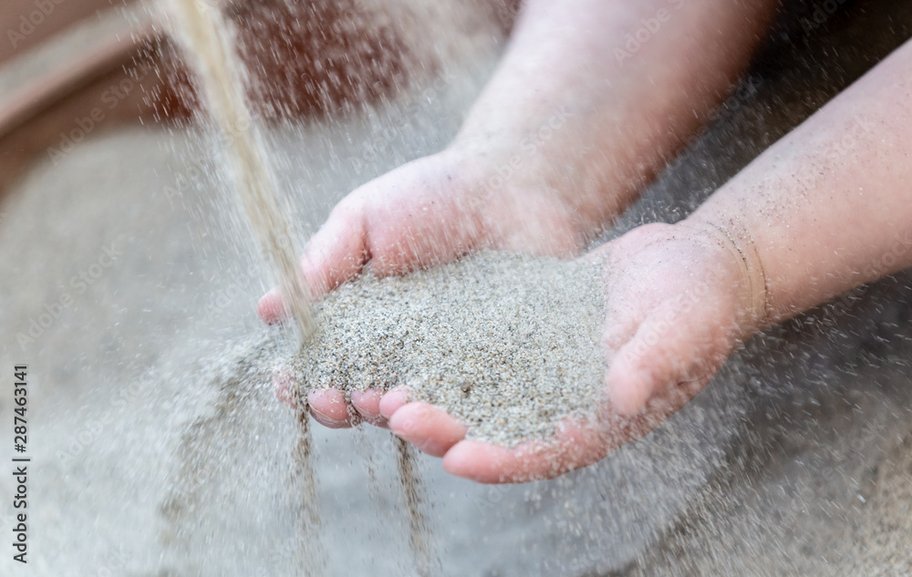 Fototapeta premium Cute kid playing with sand