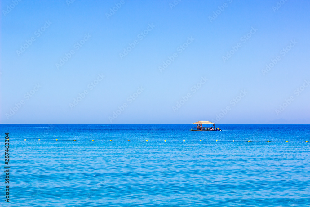 beautiful summer vacation destination Bungalow wooden house floating on a Red sea water surface in Gulf of Aqaba with horizon empty sky background with space for copy or text beautiful summer vacation destination Bungalow wooden house floating on a Red sea water surface in Gulf of Aqaba with horizon empty sky background with space for copy or text