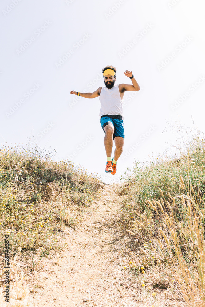 Man running up the mountain and jumping. Man running up the mountain and jumping.