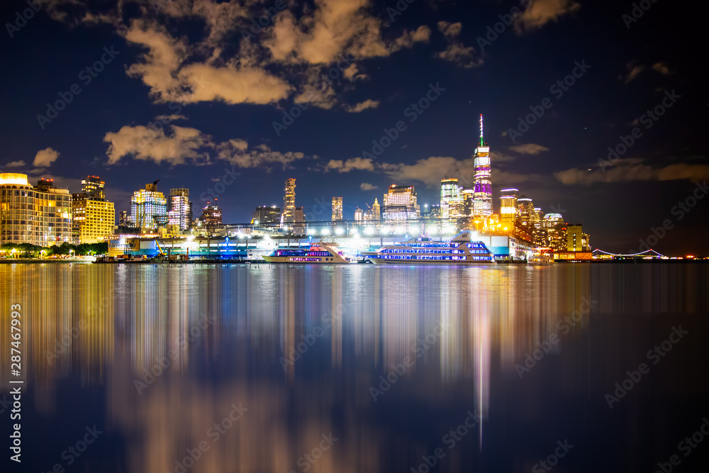 New York City skyline towards lower Manhattan Financial District at night with lights
