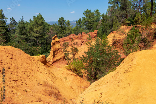 Ochre Trail in Roussillon  Hiking path in orange ocher cliffs surrounded by green forest in Provence  Southern France