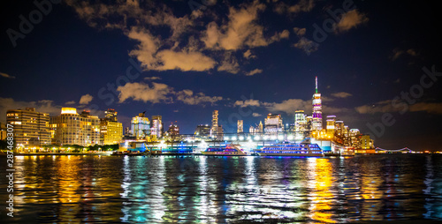 New York City skyline towards lower Manhattan Financial District at night with lights