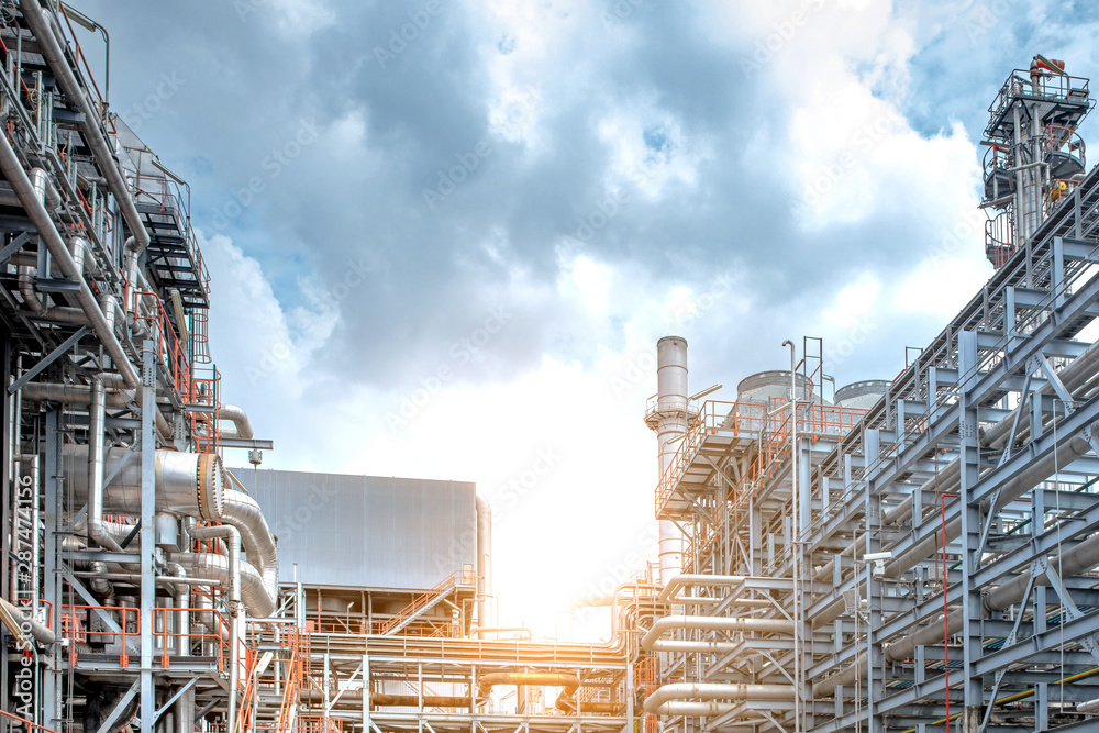 Oil and gas refinery plant form industry petroleum zone,Refinery equipment pipeline steel and oil storage tank at sunrise. -image