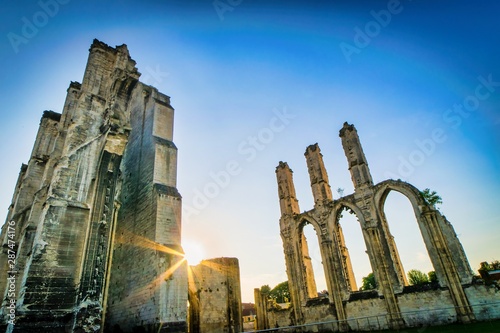 Canvas Print Dramatic Saint Bertin abbey ruins in Saint-omer in France during the sunrise with sun flare on the backgroudn