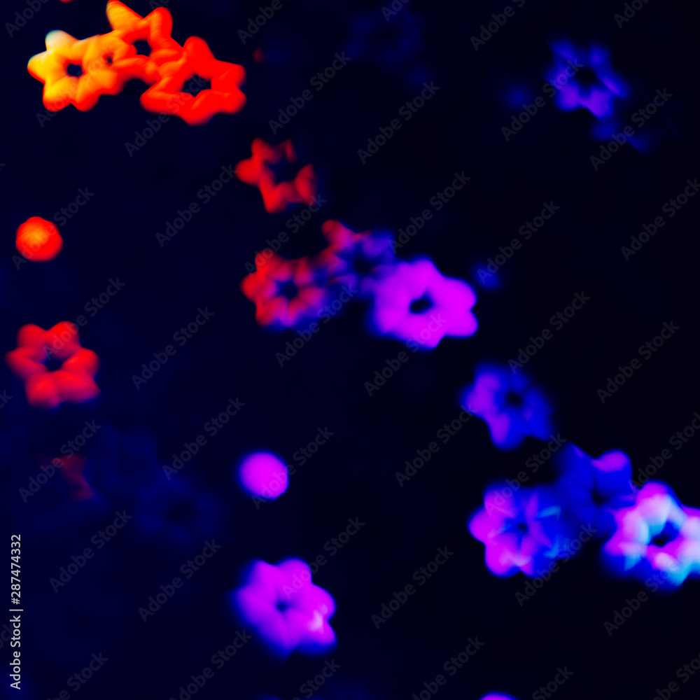 Dark abstract blurred background of glitter golographic stars.