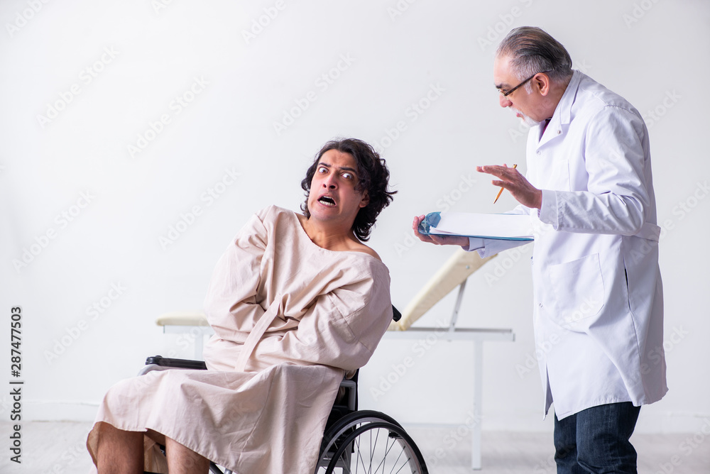 Old male doctor psychiatrist and patient in wheel-chair Old male doctor psychiatrist and patient in wheel-chair