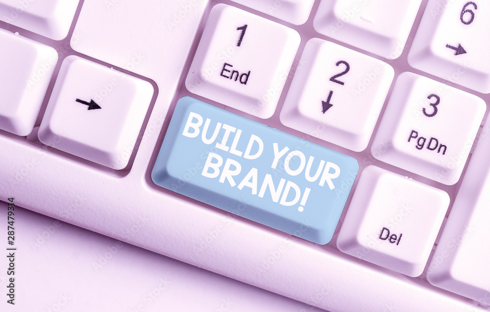 Conceptual hand writing showing Build Your Brand. Concept meaning creates or improves customers knowledge and opinions of product White pc keyboard with note paper above the white background Conceptual hand writing showing Build Your Brand. Concept meaning creates or improves customers knowledge and opinions of product White pc keyboard with note paper above the white background