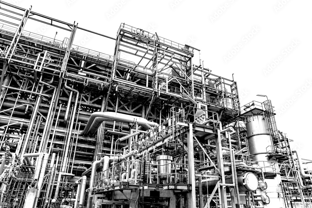 Obraz premium Close-up industrial oil and gas refinery zone,Detail of equipment oil pipeline steel with valves on-off reduce the pressure in the production at refining factory. Silhouettes on white background.