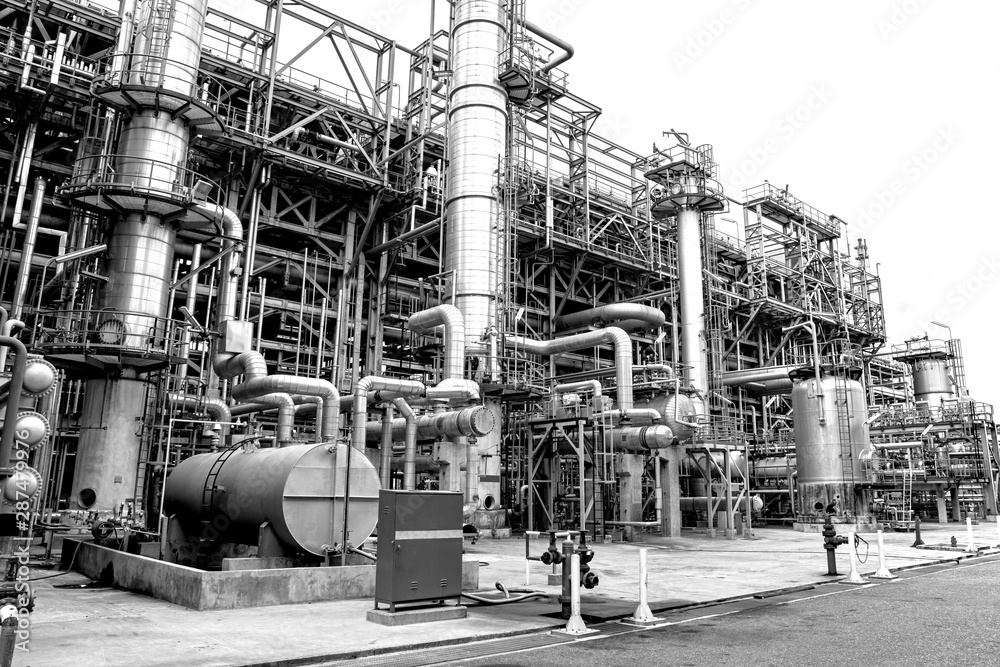 Naklejka premium Close-up industrial oil and gas refinery zone,Detail of equipment oil pipeline steel with valves on-off reduce the pressure in the production at refining factory. Silhouettes on white background.