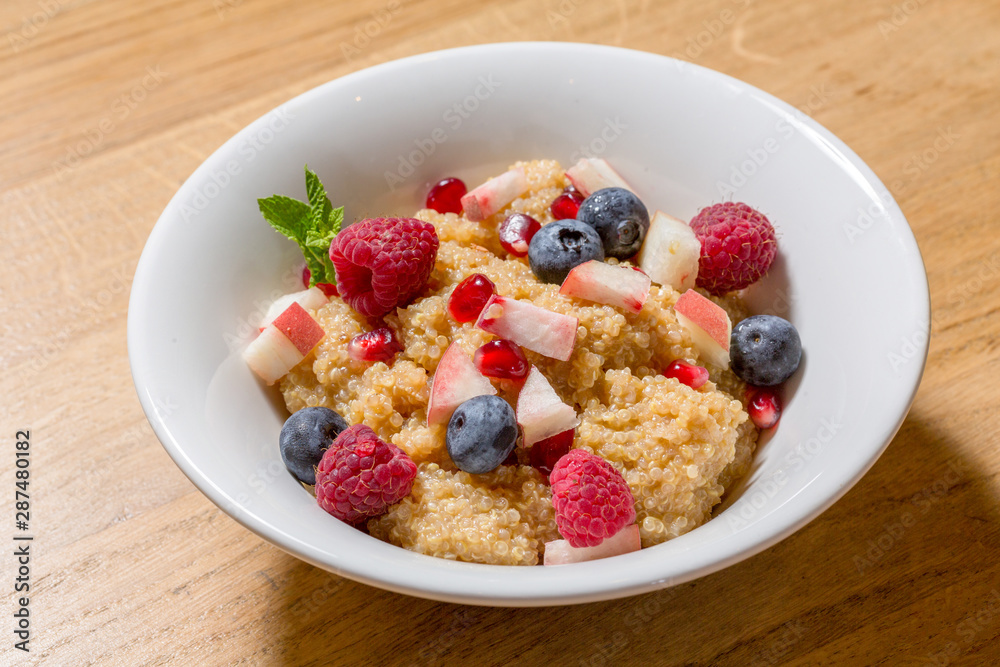 Quinoa with fruits served in white plate Quinoa with fruits served in white plate