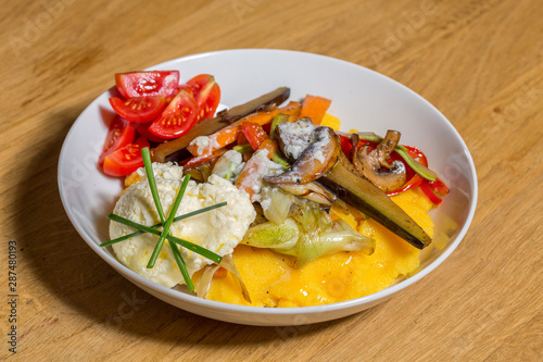 Polenta with cream cheese and vegetables photo