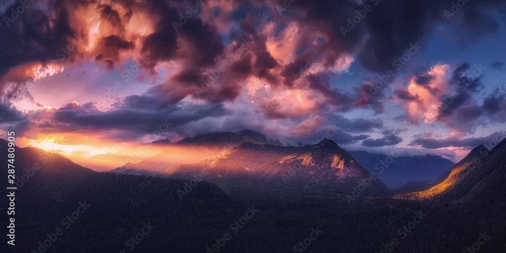 Panoramic nature mountains landscape. Dramatic sky at sunset. Aerial drone view from above