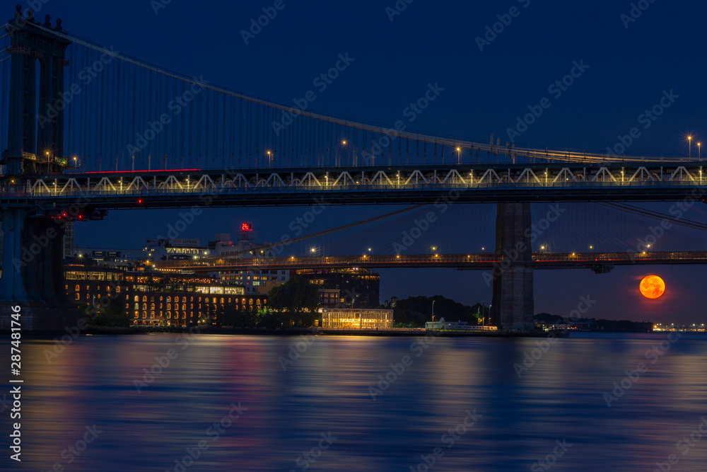 Manhattan and Brooklyn bridge with full moon set 