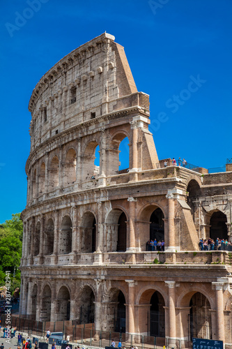 Tourists visiting the famous Colosseum in Rome in a beautiful early spring day