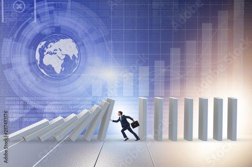 Canvas Print Businessman preventing domino effect in business concept