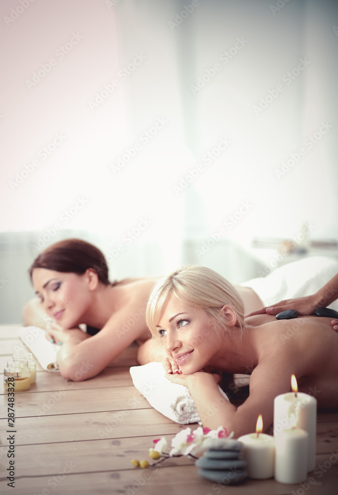 Two young beautiful women relaxing and enjoying at the spa. Two young beautiful women relaxing Two young beautiful women relaxing and enjoying at the spa. Two young beautiful women relaxing
