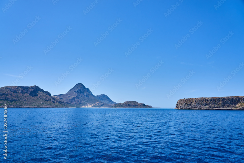  Rocky islands near Crete, Greece, with clear sky on a background and blue sea on a foreground. Copy space.