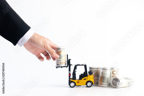 Hand of businessman pick money dollar bill wrapped in plastic from forklift, Financial concept