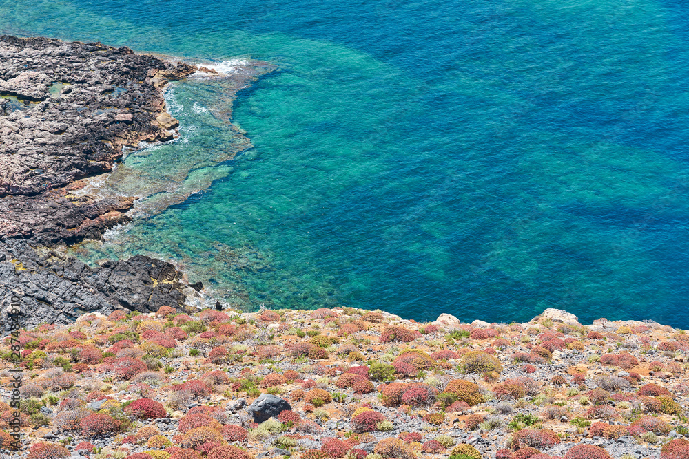                                Rocky sea coast with blue sea water in Crete, Greece. Copy space.