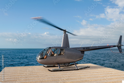 Obraz na płótnie Helicopter landing at the pontoon helipad near Reef World on the Great Barrier Reef, Whitsunday Islands. w salonie