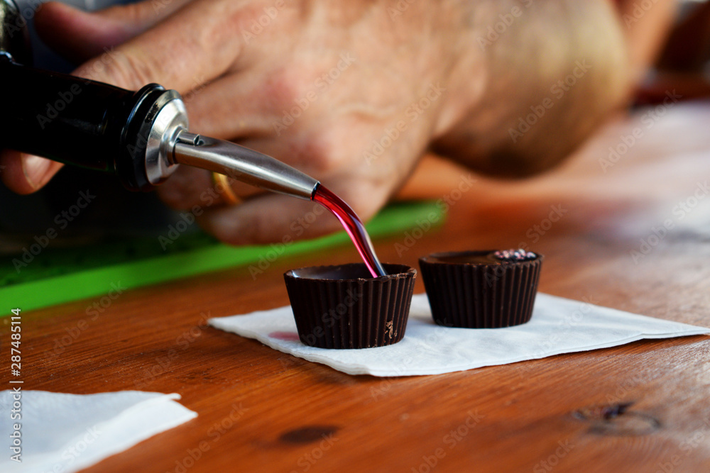 Chocolate cup filled with ginja, traditional cherry liquor Stock Photo