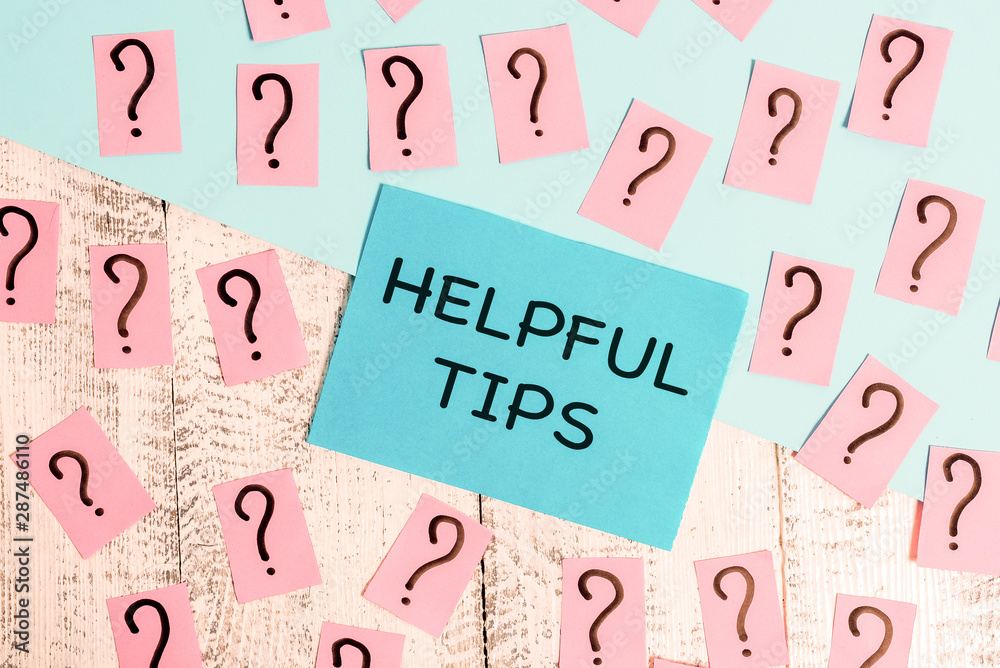 Word writing text Helpful Tips. Business photo showcasing advices given to be helpful knowledge in life Scribbled and crumbling papers with thick cardboard above wooden table