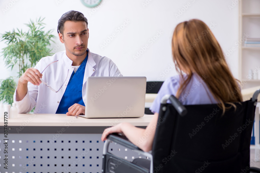 Young woman in wheel-chair visiting male doctor Young woman in wheel-chair visiting male doctor