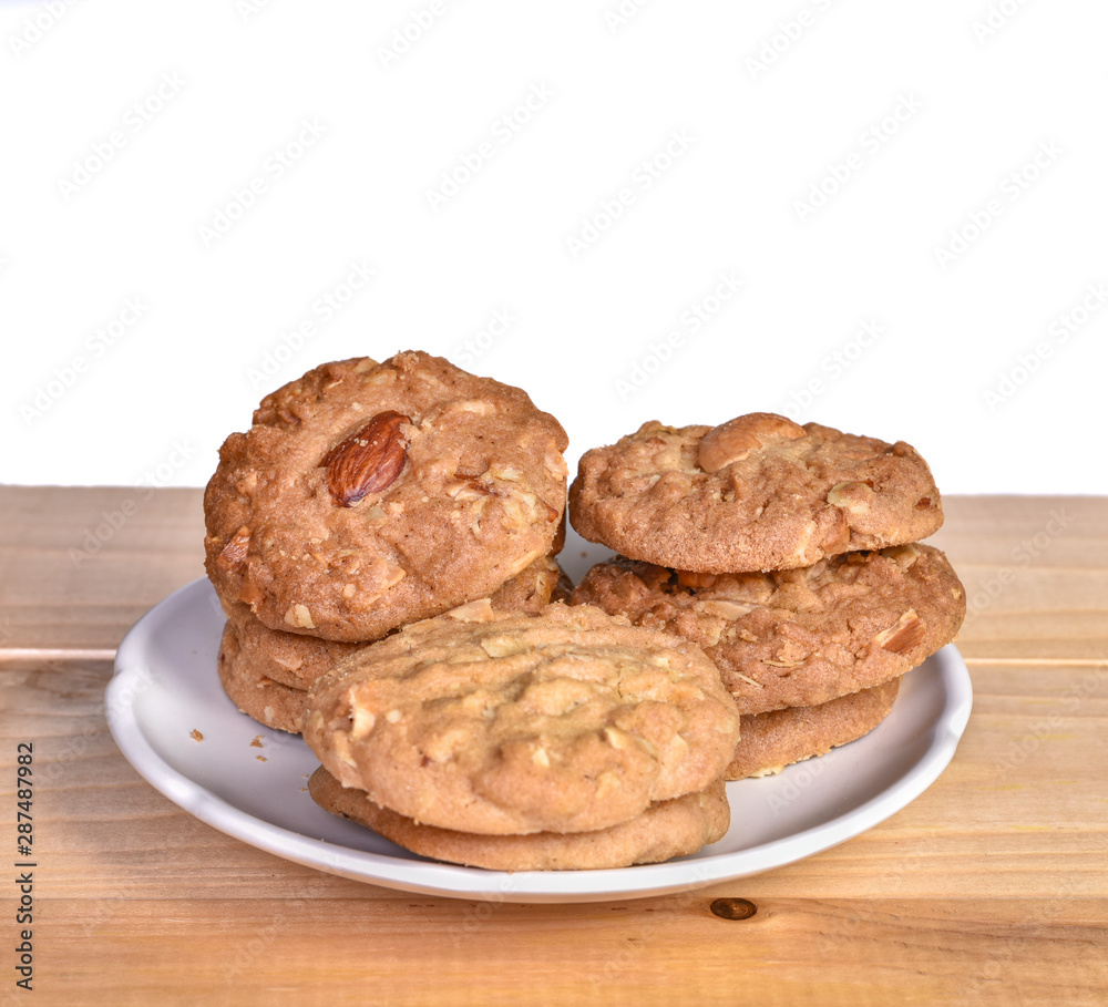 Pile of Delicious Almond Cookies on a White Plate Pile of Delicious Almond Cookies on a White Plate