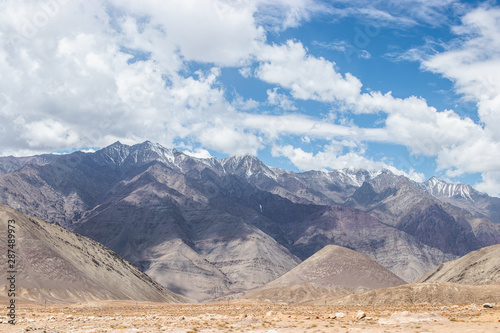 Landscape view of desert sand land with himalaya snow mountain at Leh Ladakh, India