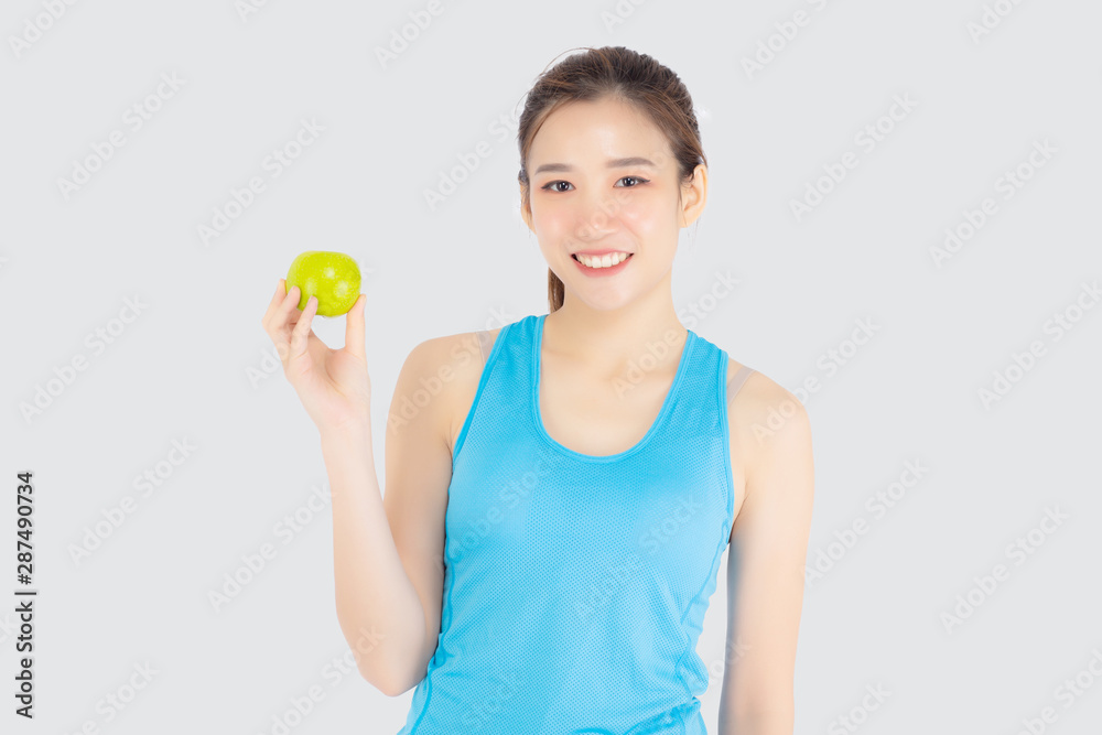 Beautiful portrait young asian woman in sport clothing with satisfied and holding green apple isolated on white background, girl asia have shape and wellness, exercise for fit with health concept. Beautiful portrait young asian woman in sport clothing with satisfied and holding green apple isolated on white background, girl asia have shape and wellness, exercise for fit with health concept.
