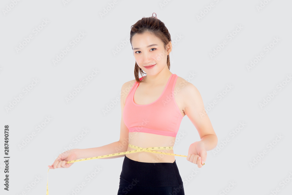 Beautiful slim young asian woman measuring tape thin waist wear uniform fitness isolated white background, asia girl loss weight for diet with exercise and workout wellbeing and healthy care body. Beautiful slim young asian woman measuring tape thin waist wear uniform fitness isolated white background, asia girl loss weight for diet with exercise and workout wellbeing and healthy care body.