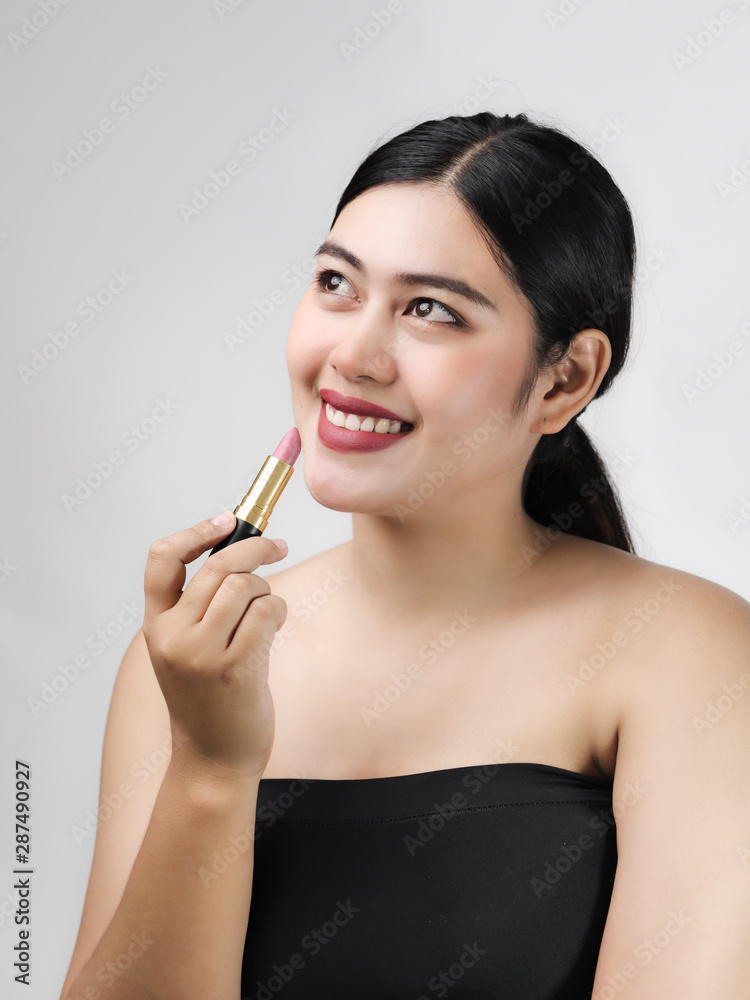 Young Asian woman model with bright makeup with perfect clean skin with pink lips and lipstick.