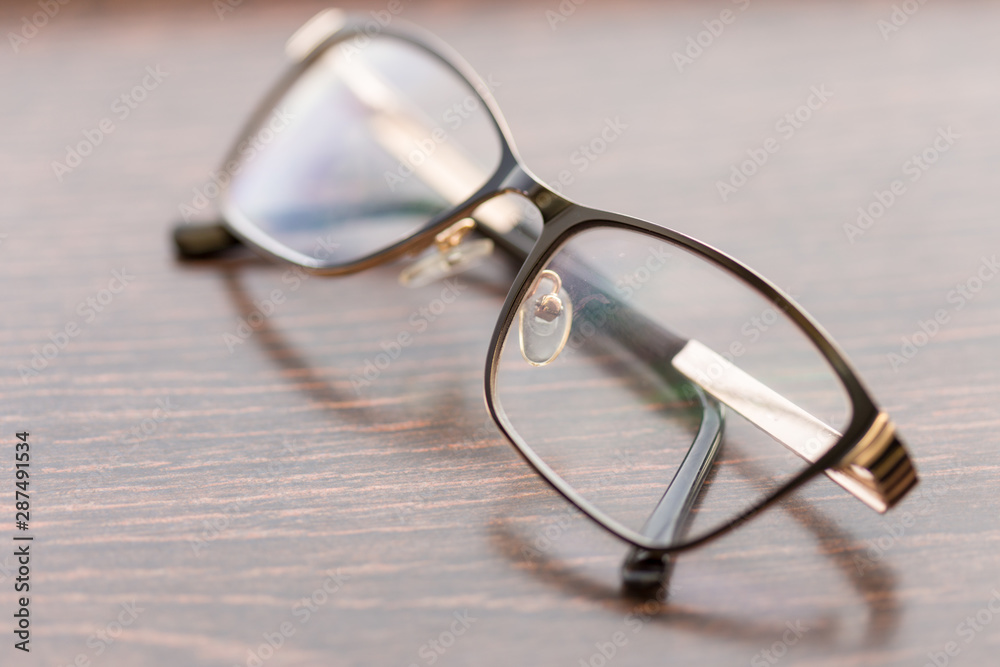 Brown glasses close-up. Glasses in a modern style. Glasses with clear lenses. fashionable accessories Brown glasses close-up. Glasses in a modern style. Glasses with clear lenses. fashionable accessories