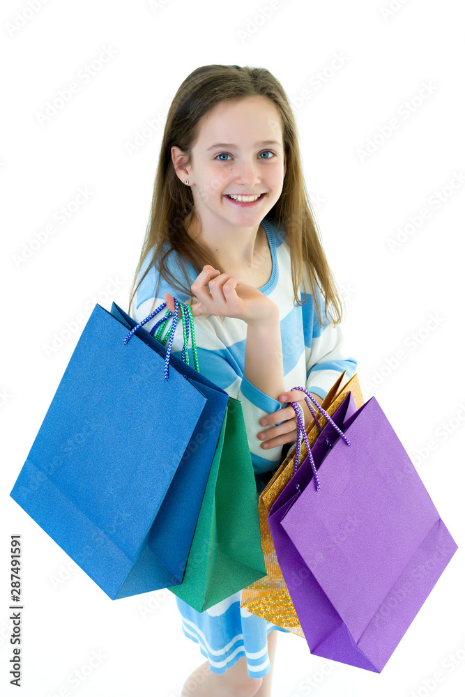 Teenager girl shopping in a store with large paper bags. Teenager girl shopping in a store with large paper bags.