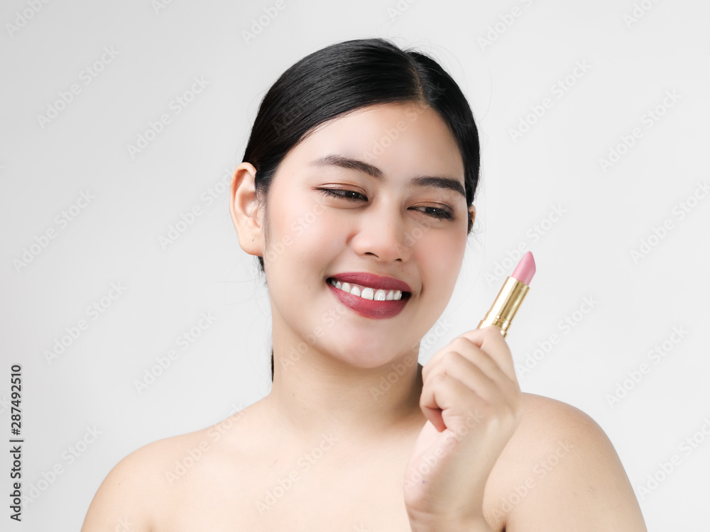Young Asian woman model with bright makeup with perfect clean skin with pink lips and lipstick. Young Asian woman model with bright makeup with perfect clean skin with pink lips and lipstick.