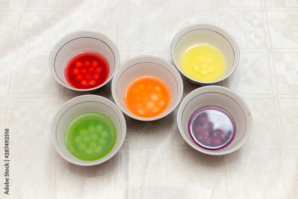 multi-colored sweets dissolve in water, all paints and harmful substances fall into the water, it is dangerous for children and for humans multi-colored sweets dissolve in water, all paints and harmful substances fall into the water, it is dangerous for children and for humans