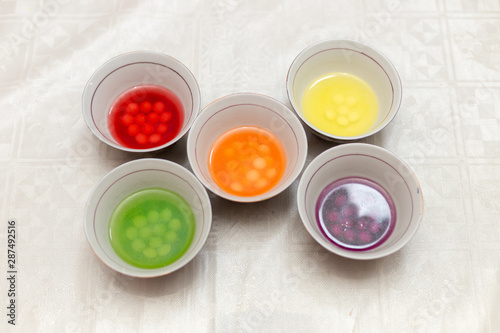 multi-colored sweets dissolve in water, all paints and harmful substances fall into the water, it is dangerous for children and for humans