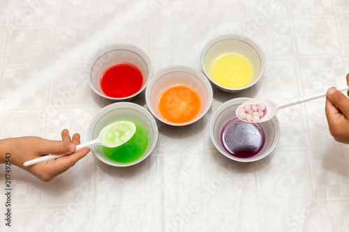 multi-colored sweets dissolve in water, all paints and harmful substances fall into the water, it is dangerous for children and for humans