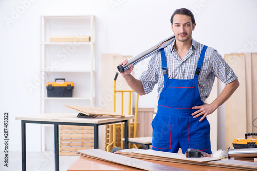 Young male carpenter working indoors