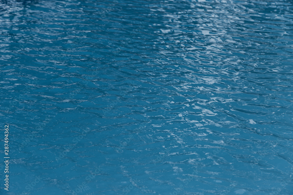 Blue swimming pool edge with refection of water ripple Blue swimming pool edge with refection of water ripple