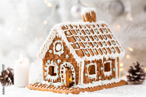 Homemade gingerbread house on a light background with bokeh, selective focus