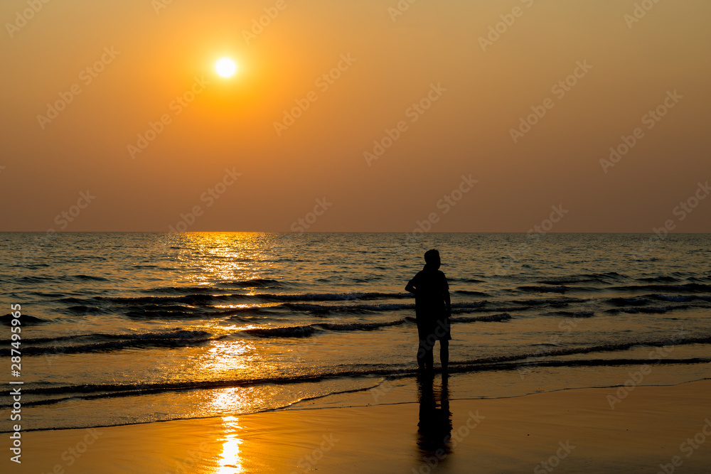 Siluate lovers and beach before sunset