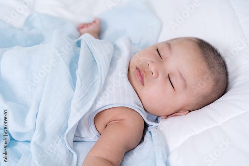 baby sleeping on a bed at home