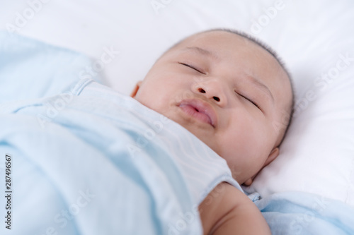 baby sleeping on a bed at home