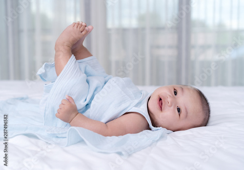 baby move leg in the air on a bed